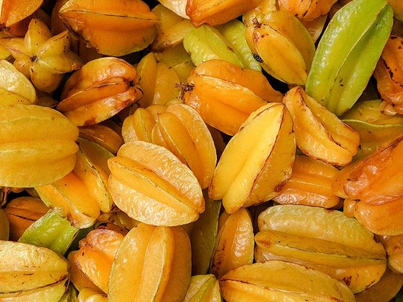 Pile of whole ripe yellow and green starfruit (carambola) for wholesale supply